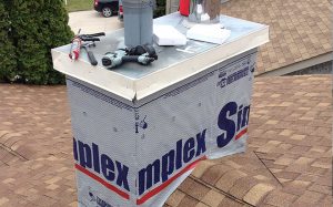 Chimney repair project with new flashing and capping installed